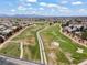 Scenic aerial view of a community featuring expansive green spaces, a golf course, and mountain backdrop at 5655 E Sahara Ave # 2044, Las Vegas, NV 89142