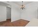Cozy dining area with hardwood floors and decorative chandelier, adjacent to a hallway at 5655 E Sahara Ave # 2044, Las Vegas, NV 89142