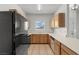 Well-lit kitchen shows wood cabinets, black appliances, and tile flooring at 5655 E Sahara Ave # 2044, Las Vegas, NV 89142
