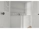 Laundry closet features white washer, dryer, and shelving above at 5655 E Sahara Ave # 2044, Las Vegas, NV 89142