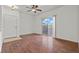 Spacious living room featuring hardwood floors, a sliding glass door, and a front door entry at 5655 E Sahara Ave # 2044, Las Vegas, NV 89142