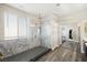 Modern bathroom featuring a glass shower, elegant vanity, and wood-look flooring at 5832 Ivy Vine Ct, Las Vegas, NV 89141
