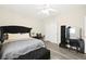 Bedroom featuring laminate floors, ceiling fan, and window with blinds, and a velvet bed at 5832 Ivy Vine Ct, Las Vegas, NV 89141