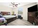 Bedroom with wood floors, large window, and ceiling fan at 5832 Ivy Vine Ct, Las Vegas, NV 89141