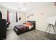 A bedroom featuring laminate floors, ceiling fan, and window with blinds and Spider-Personal decor at 5832 Ivy Vine Ct, Las Vegas, NV 89141