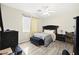 Bedroom featuring laminate floors, ceiling fan, and window with blinds, and a velvet bed at 5832 Ivy Vine Ct, Las Vegas, NV 89141