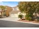 Attractive home with a three-car garage and easy-care desert landscaping at 5832 Ivy Vine Ct, Las Vegas, NV 89141