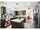 Well-lit kitchen with granite countertops, dark cabinets, and stainless steel appliances at 5832 Ivy Vine Ct, Las Vegas, NV 89141