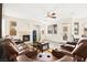Inviting living room featuring a cozy fireplace and comfortable, plush leather seating at 5832 Ivy Vine Ct, Las Vegas, NV 89141