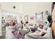 Bright living room with large windows, high ceilings, and modern decor at 5832 Ivy Vine Ct, Las Vegas, NV 89141