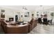 Open-concept living room with a fireplace, wood floors, and plenty of seating at 5832 Ivy Vine Ct, Las Vegas, NV 89141
