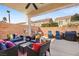Covered patio featuring a ceiling fan and ample seating for outdoor entertaining at 5832 Ivy Vine Ct, Las Vegas, NV 89141