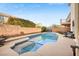 Inviting backyard pool and spa with decorative tile, surrounded by a spacious deck and mature landscaping at 5832 Ivy Vine Ct, Las Vegas, NV 89141