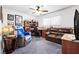 Comfortable bedroom with a ceiling fan, desk, leather couch, and sports themed decor at 5921 Halifax Ave, Las Vegas, NV 89107