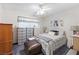 A serene bedroom featuring a ceiling fan, soft colors, and an upholstered ottoman at 5921 Halifax Ave, Las Vegas, NV 89107
