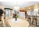 Bright dining area with chandelier, an adjacent breakfast bar, and a view to the kitchen at 5921 Halifax Ave, Las Vegas, NV 89107
