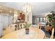 Open floorplan featuring dining area with modern chandelier and breakfast bar with seating at 5921 Halifax Ave, Las Vegas, NV 89107