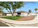 A quaint single-story home with manicured lawn and fence at 5921 Halifax Ave, Las Vegas, NV 89107