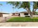 Charming single-story home featuring a well-manicured lawn and brick accents at 5921 Halifax Ave, Las Vegas, NV 89107