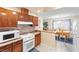 Functional kitchen with wood cabinets, laminate countertops, and a view into the dining area at 5921 Halifax Ave, Las Vegas, NV 89107