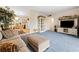 A cozy living room features soft blue carpet and seamless access to the dining area at 5921 Halifax Ave, Las Vegas, NV 89107