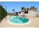 A kidney-shaped pool and lush greenery create a tranquil backyard at 5921 Halifax Ave, Las Vegas, NV 89107
