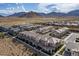Panoramic aerial view highlighting community homes, desert landscape, and distant mountain backdrop at 6150 Foxes Dale St, Las Vegas, NV 89166