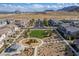 Wide aerial view showcasing the community layout with a playground and desert landscape at 6150 Foxes Dale St, Las Vegas, NV 89166