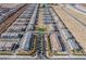 An aerial view shows a community with tidy rows of modern homes, desert landscaping, and well-maintained roads and walkways at 6150 Foxes Dale St, Las Vegas, NV 89166