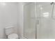 Bathroom with toilet, and modern walk-in shower with a glass door and white tile at 6150 Foxes Dale St, Las Vegas, NV 89166