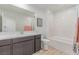 Bathroom featuring a long vanity with large mirror and a tub shower at 6150 Foxes Dale St, Las Vegas, NV 89166