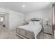 Bedroom features a neutral palette, carpet, and decorative lamps at 6150 Foxes Dale St, Las Vegas, NV 89166