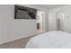 Spacious bedroom with TV, neutral decor, and views into both the bathroom and hallway at 6150 Foxes Dale St, Las Vegas, NV 89166