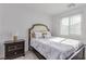 Cozy bedroom with a bed and a wooden nightstand with lamp at 6150 Foxes Dale St, Las Vegas, NV 89166