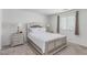 Bedroom features a neutral palette, carpet, and decorative lamps at 6150 Foxes Dale St, Las Vegas, NV 89166