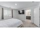 Bedroom view shows the window, TV, open doorway to bathroom with double sinks, and modern decor at 6150 Foxes Dale St, Las Vegas, NV 89166