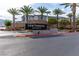 Well-maintained community entrance with a Centennial Heights sign and palm tree lined road at 6150 Foxes Dale St, Las Vegas, NV 89166