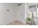 Bright entryway features a modern light fixture, a white door, and wood-look floors at 6150 Foxes Dale St, Las Vegas, NV 89166