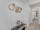 Upstairs hallway featuring gray carpeting, decorative wall art, and a console table at 6150 Foxes Dale St, Las Vegas, NV 89166
