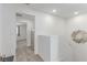 Bright upstairs hallway featuring plush gray carpet and a modern decorative mirror at 6150 Foxes Dale St, Las Vegas, NV 89166