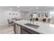 Bright, open floor plan with modern kitchen island, dining area, and comfortable living space at 6150 Foxes Dale St, Las Vegas, NV 89166