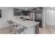 Modern kitchen features stainless steel appliances, and a breakfast bar with comfortable seating at 6150 Foxes Dale St, Las Vegas, NV 89166