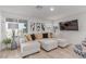 Bright living room with comfortable sectional sofa and large window view at 6150 Foxes Dale St, Las Vegas, NV 89166