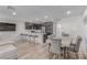 Inviting living room with modern kitchen, dining area, and breakfast bar seating at 6150 Foxes Dale St, Las Vegas, NV 89166