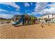 A colorful playground offers fun for children, set amongst neatly landscaped grounds in a modern residential community at 6150 Foxes Dale St, Las Vegas, NV 89166