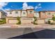 Charming townhomes featuring neat landscaping, multi-car garages, and neutral exteriors at 6150 Foxes Dale St, Las Vegas, NV 89166