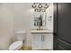The half bath is equipped with a new vanity, rectangular mirror with a multi-bulb light fixture, and a neutral color palette at 62 Incline Village Ct, Henderson, NV 89074
