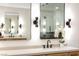 Stylish bathroom featuring double sinks, sleek faucets, and modern lighting fixtures at 62 Incline Village Ct, Henderson, NV 89074