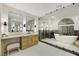 Elegant bathroom with dual sinks, large mirrors, and a luxurious soaking tub at 62 Incline Village Ct, Henderson, NV 89074
