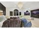 Open concept bedroom featuring dark accent wall, modern lighting, and sitting area with large windows at 62 Incline Village Ct, Henderson, NV 89074